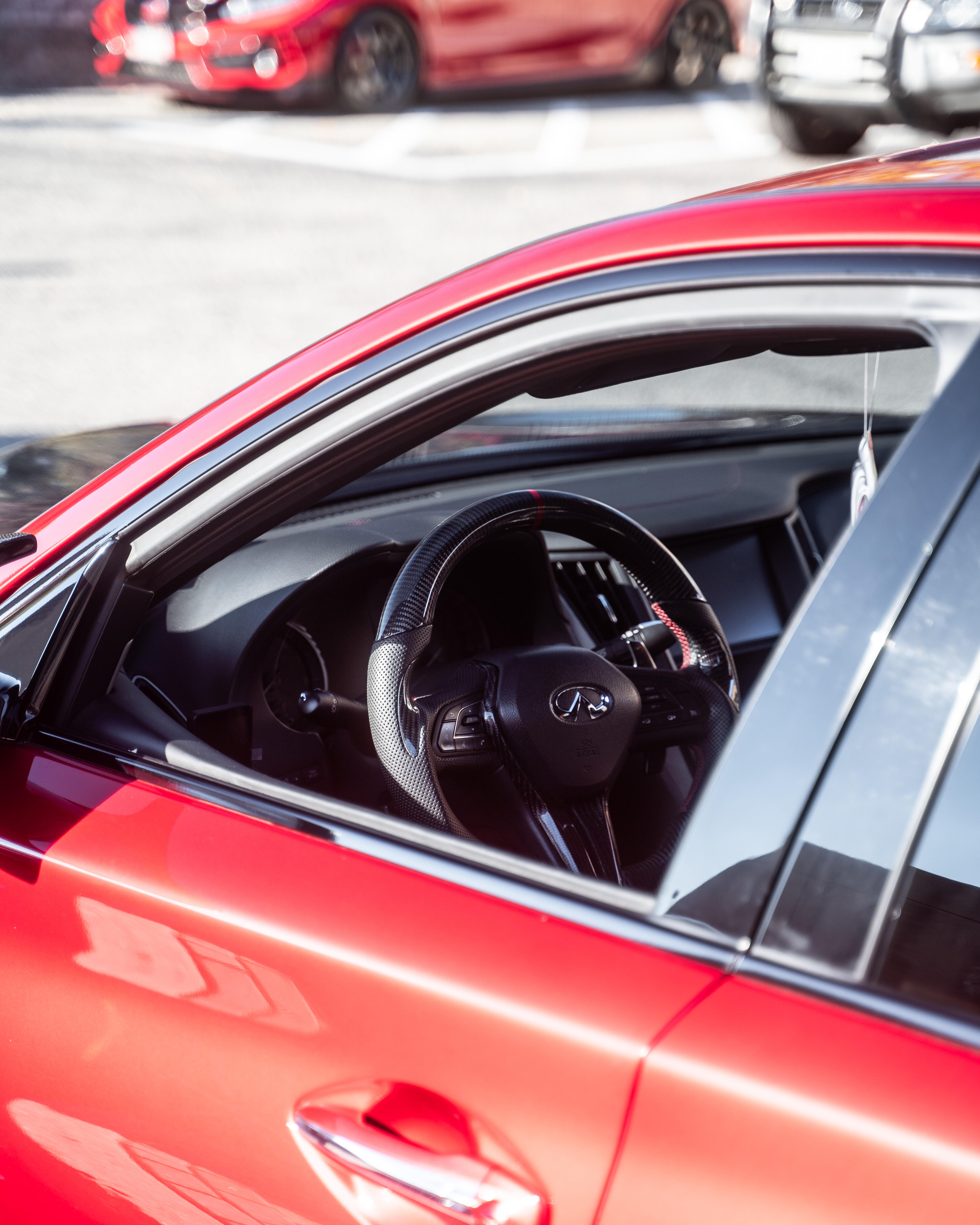 Red carbon steering wheel installed in a vehicle